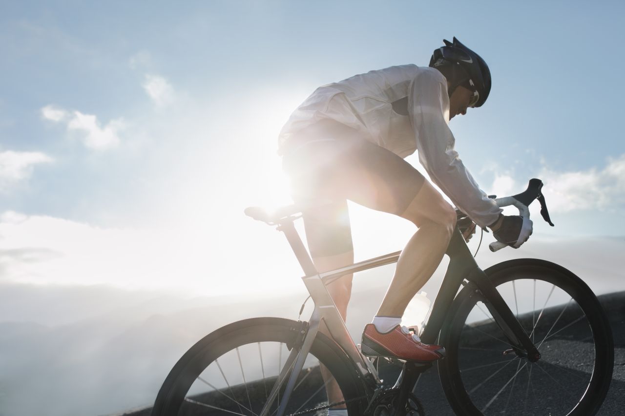 A silhouette of a road cyclist