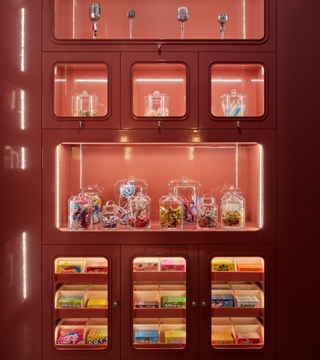 a red storage cabinet filled with sweets