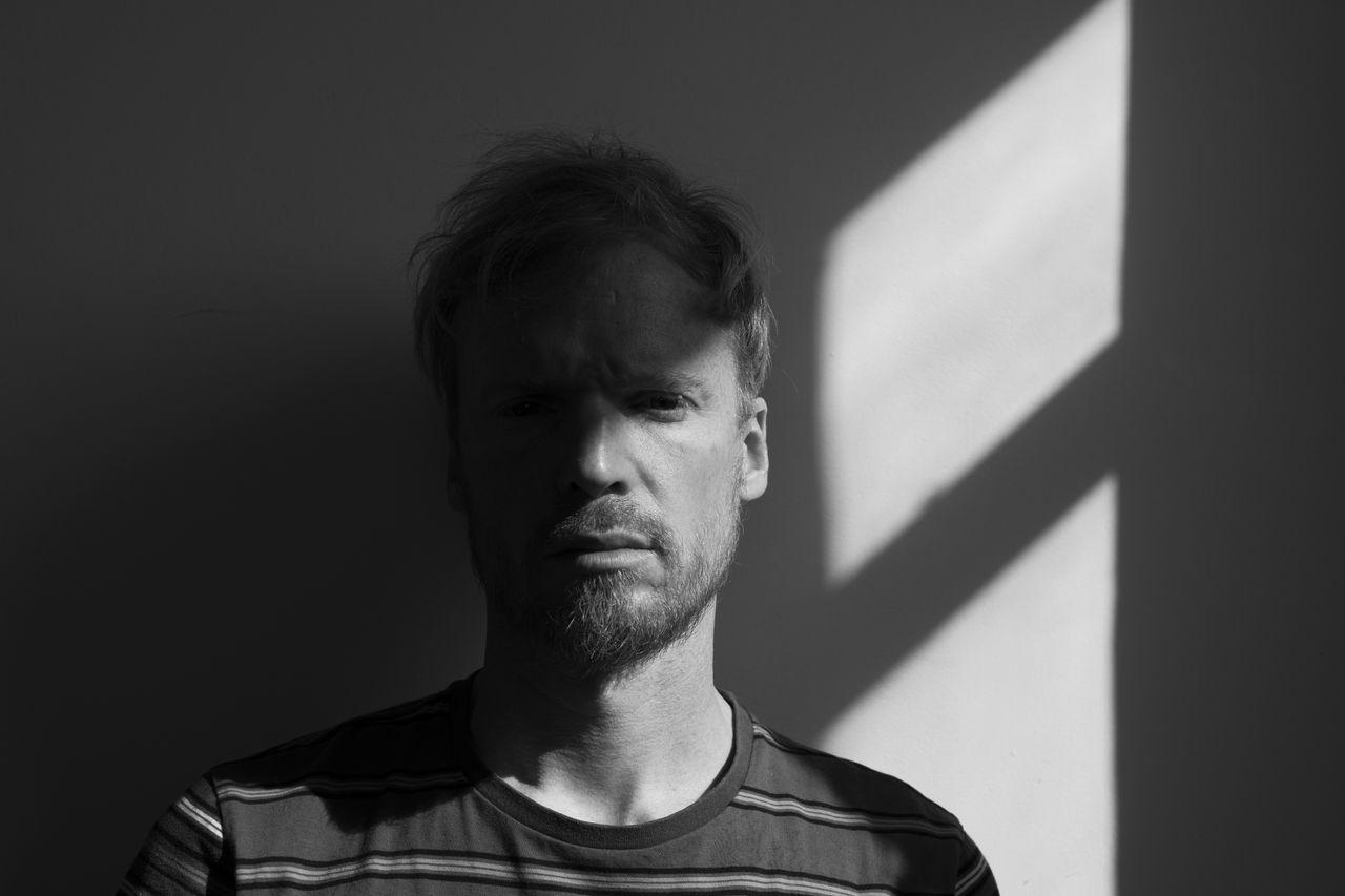 A man sitting next to a window