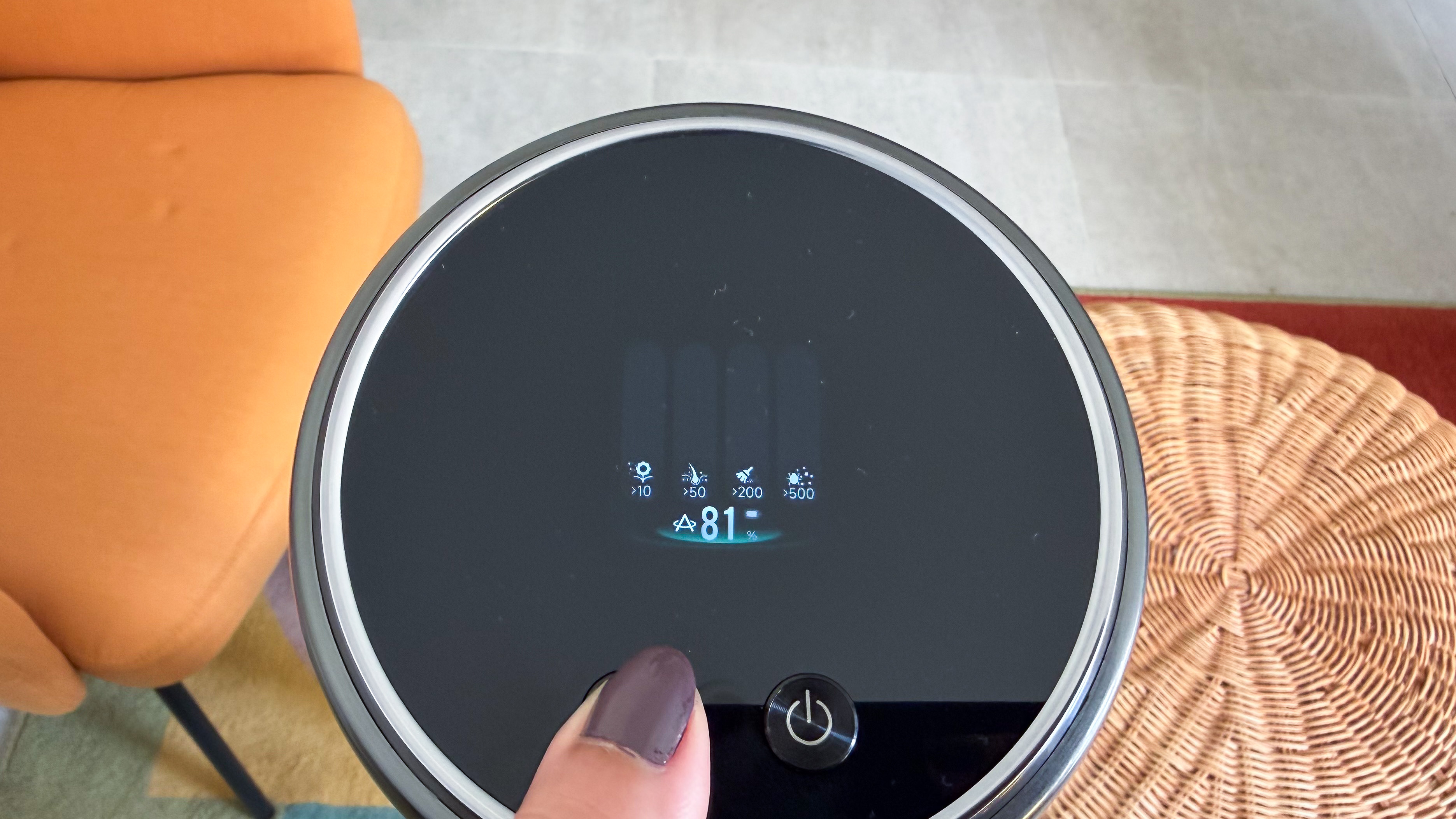 A thumb pressing the suction button on the Dreame Z50 Station