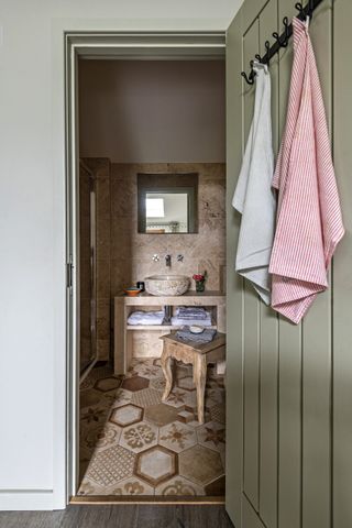 bathroom with green door and washbasin
