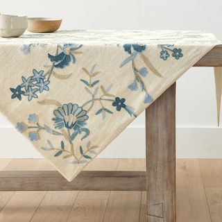 Liana Crewel Embroidered Cotton/Linen Table Throw on a table.