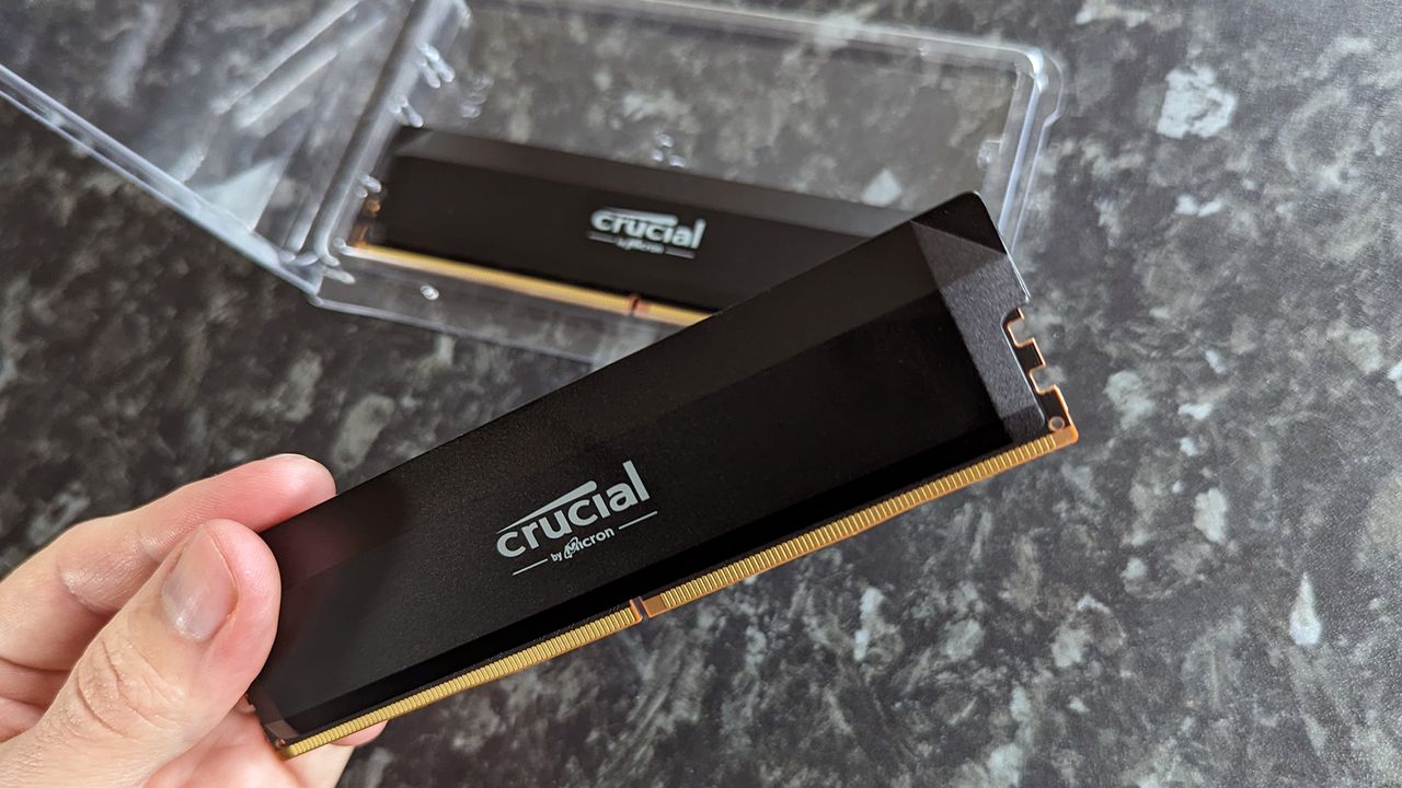 Crucial Pro Series Overclocking Edition DDR5 RAM held in hand with front logo showing