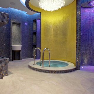 personal spa room with chandelier and tiles on wall