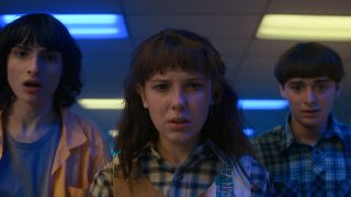Eleven, Mike and Will look shocked in this image from Stranger Things 4