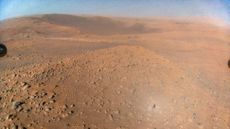 NASA's Perseverance rover can be seen in the background, while rocks and red Martian soil take up the rest of the image.