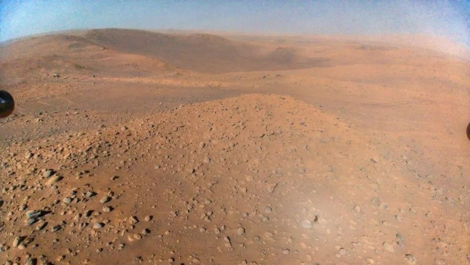 NASA&#039;s Perseverance rover can be seen in the background, while rocks and red Martian soil take up the rest of the image.