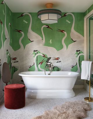 modern bathroom with Gucci swan mural in green and rounded bath