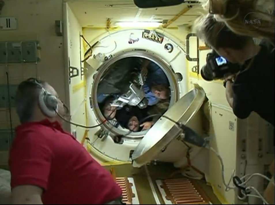 The crew of Expedition 36, NASA astronaut Chris Cassidy (center) and Russian cosmonauts Pavel Vinogradov and Alexander Misurkin, wave as they enter their Soyuz spacecraft to return to Earth from the International Space Station on Sept. 10, 2013.