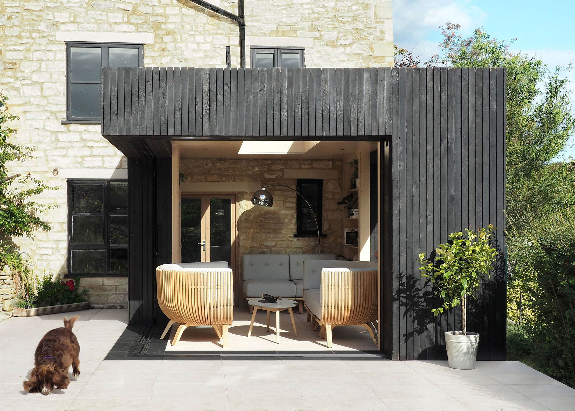 extension with charred timber cladding and corner sliding doors