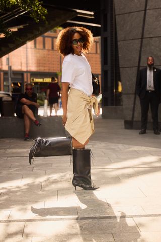 woman wearing white t-shirt, skirt, jacket, and boots