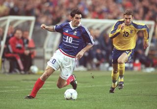 Robert Pires on the ball for France against Ukraine in 1999 as Andriy Shevchenko gives chase.