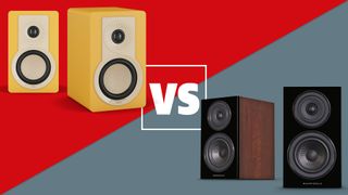 A pair of yellow Dali Kupid and Wharfedale Diamond 12.1 speakers on a red and grey background with a white versus sign between them.