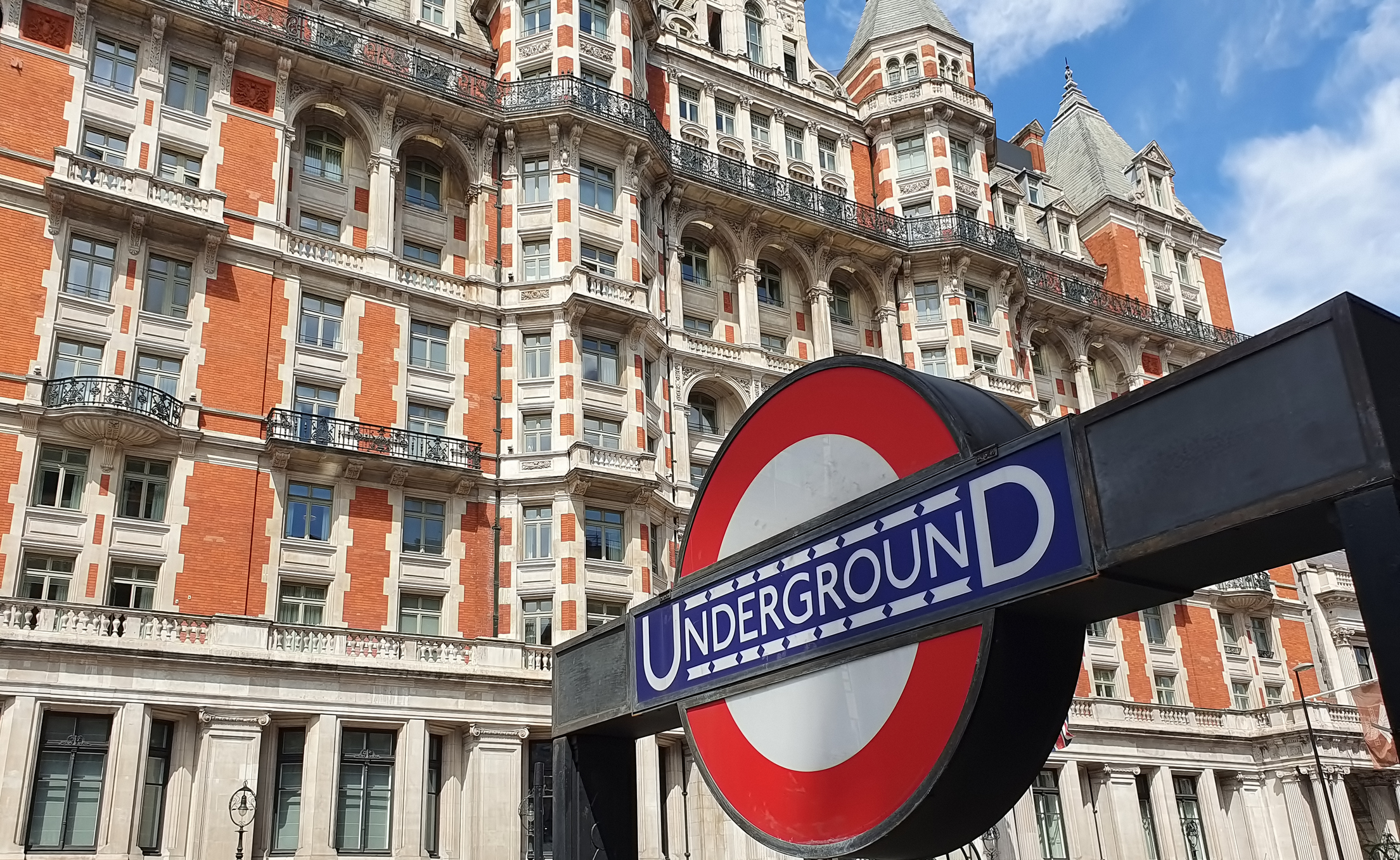 London subway sign against ornate Victorian palace in Knightsbridge, London