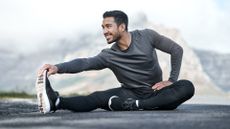 Full length shot of a handsome young man stretching before exercising outdoors alone