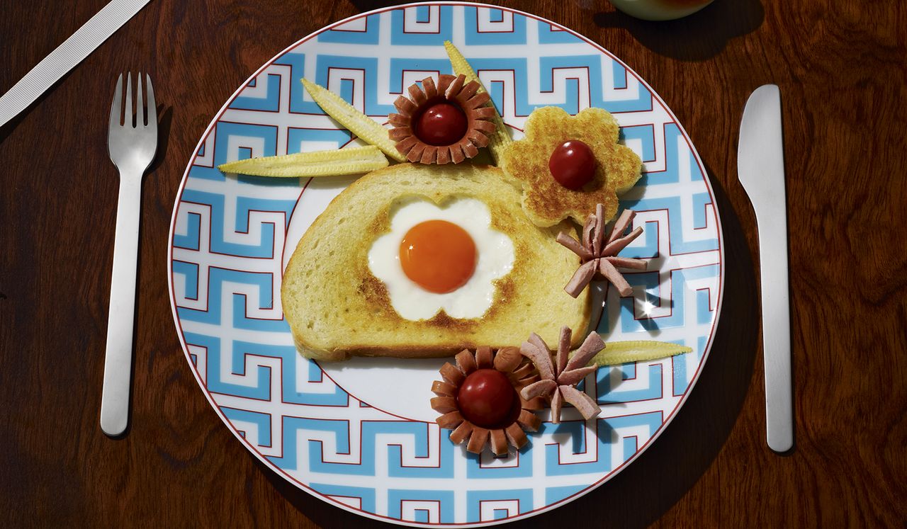 toast with egg shaped like a flower in the middle of it