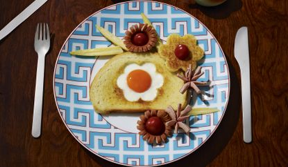 toast with egg shaped like a flower in the middle of it
