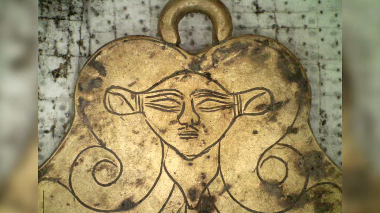 This gold pendant was found in one of the tombs and depicts Hathor, an Egyptian goddess who was regarded as a protector of the dead.