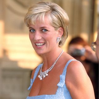 Princess Diana wearing a blue dress and smiling 