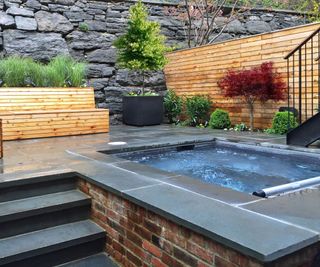 small urban backyard with built in hot tub on patio