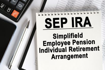 On the table lies a smartphone, a calculator and a notebook with the inscription- SEP IRA. Simplified Employee Pension. Business concept