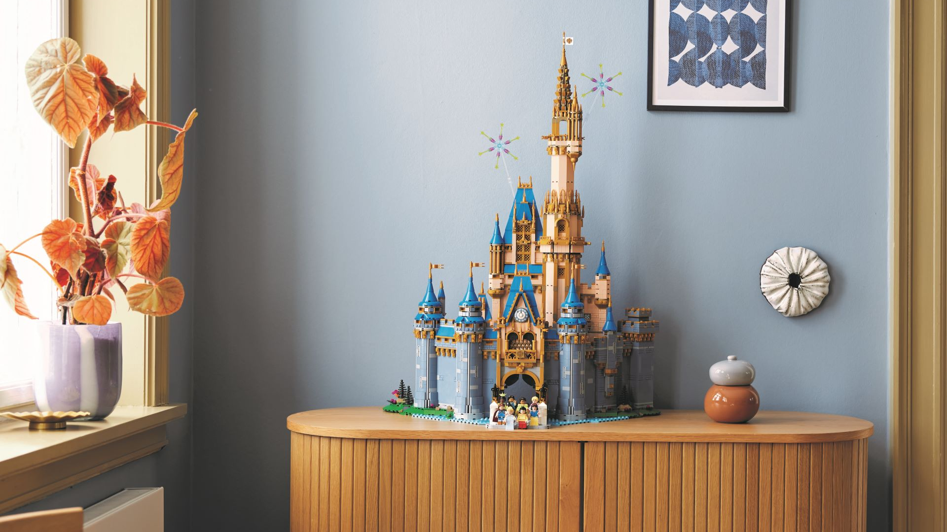 The Lego Disney Castle sat on a wooden sideboard