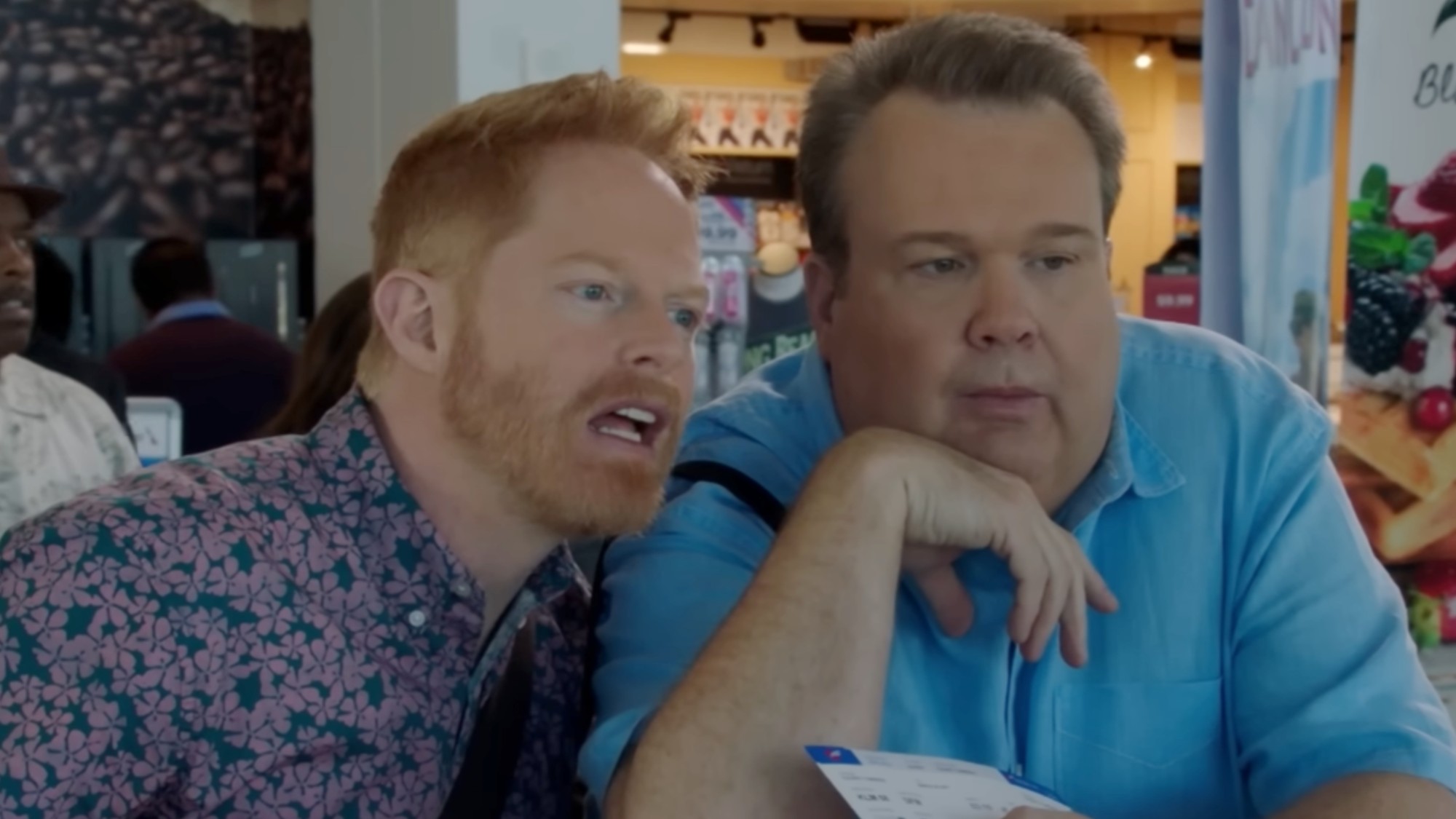 Jesse Tyler Ferguson and Eric Stonestreet standing close together and looking confused in Modern Family.