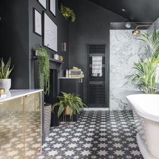 grey bathroom with plants, tiled floor and marble tiled shower