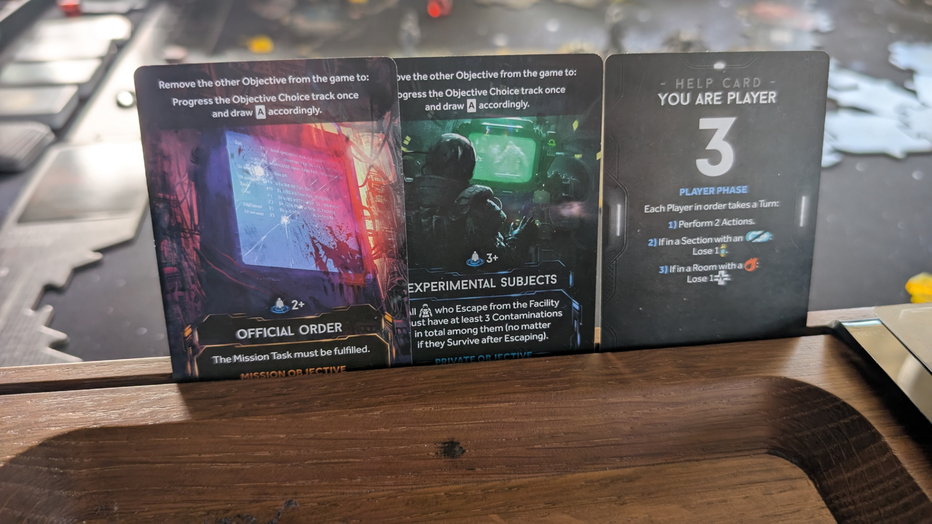 Nemesis: Retaliation cards standing vertically on a gaming table