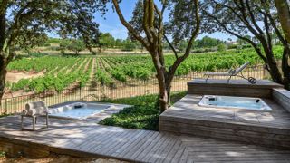 Relax in the outdoor Jacuzzis next to the vineyard