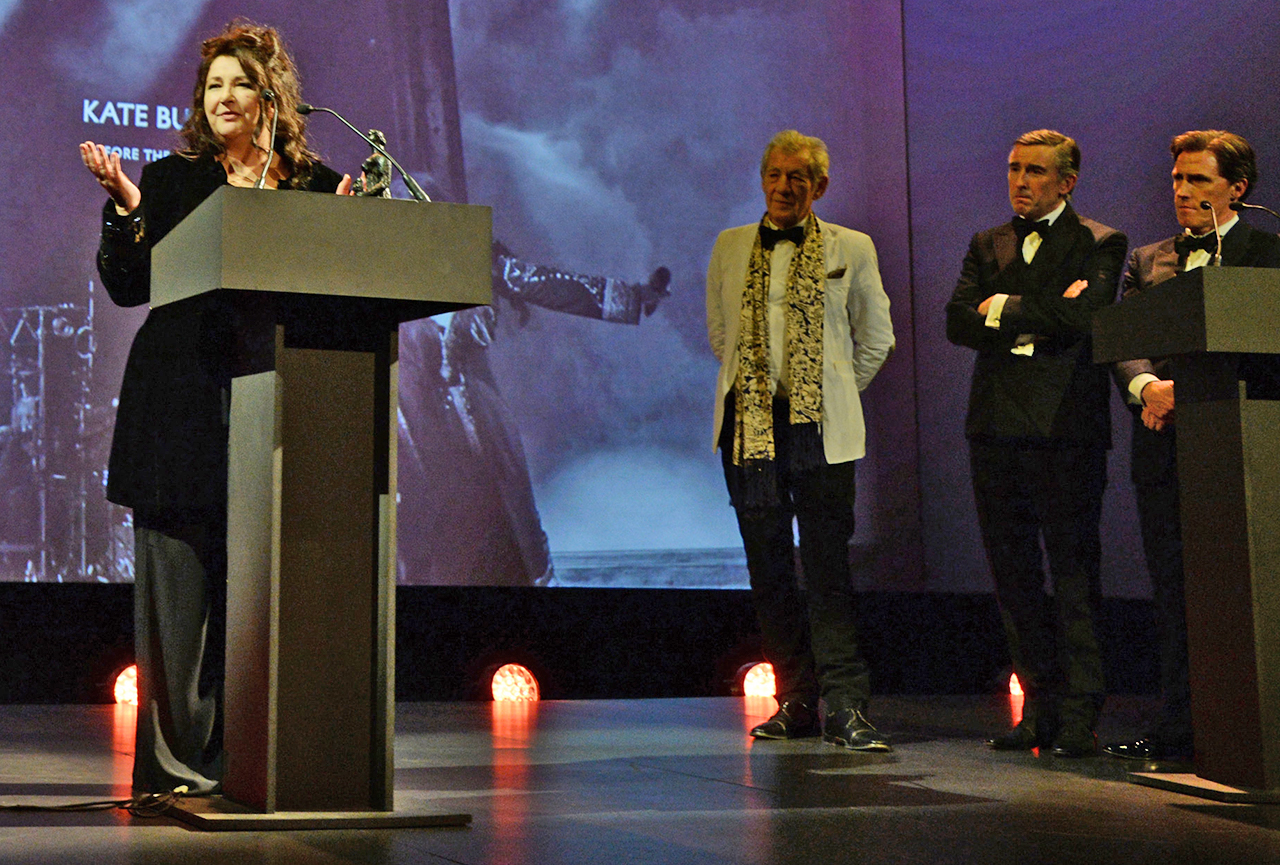 Kate Bush accepts the Editor's Award for 'Before The Dawn' as Sir Ian McKellen and hosts Steve Coogan and Rob Brydon look on at the 60th London Evening Standard Theatre Awards, November 30, 2014 .