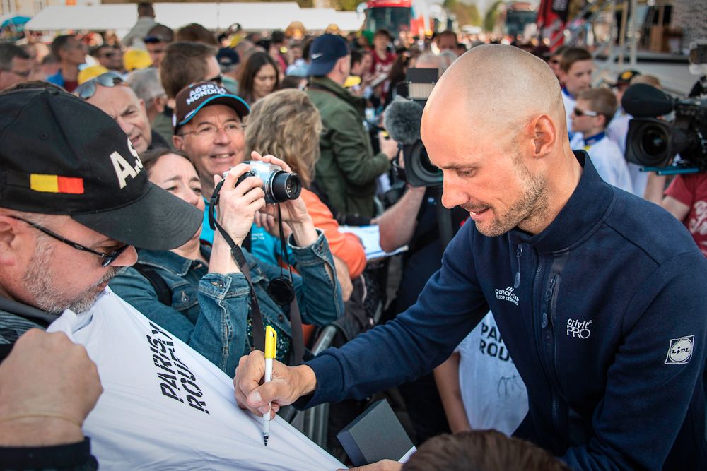 Tom Boonen signs a T-shirt for a fan after the team presentation on April 8, 2017 on the eve of the Paris-Roubaix