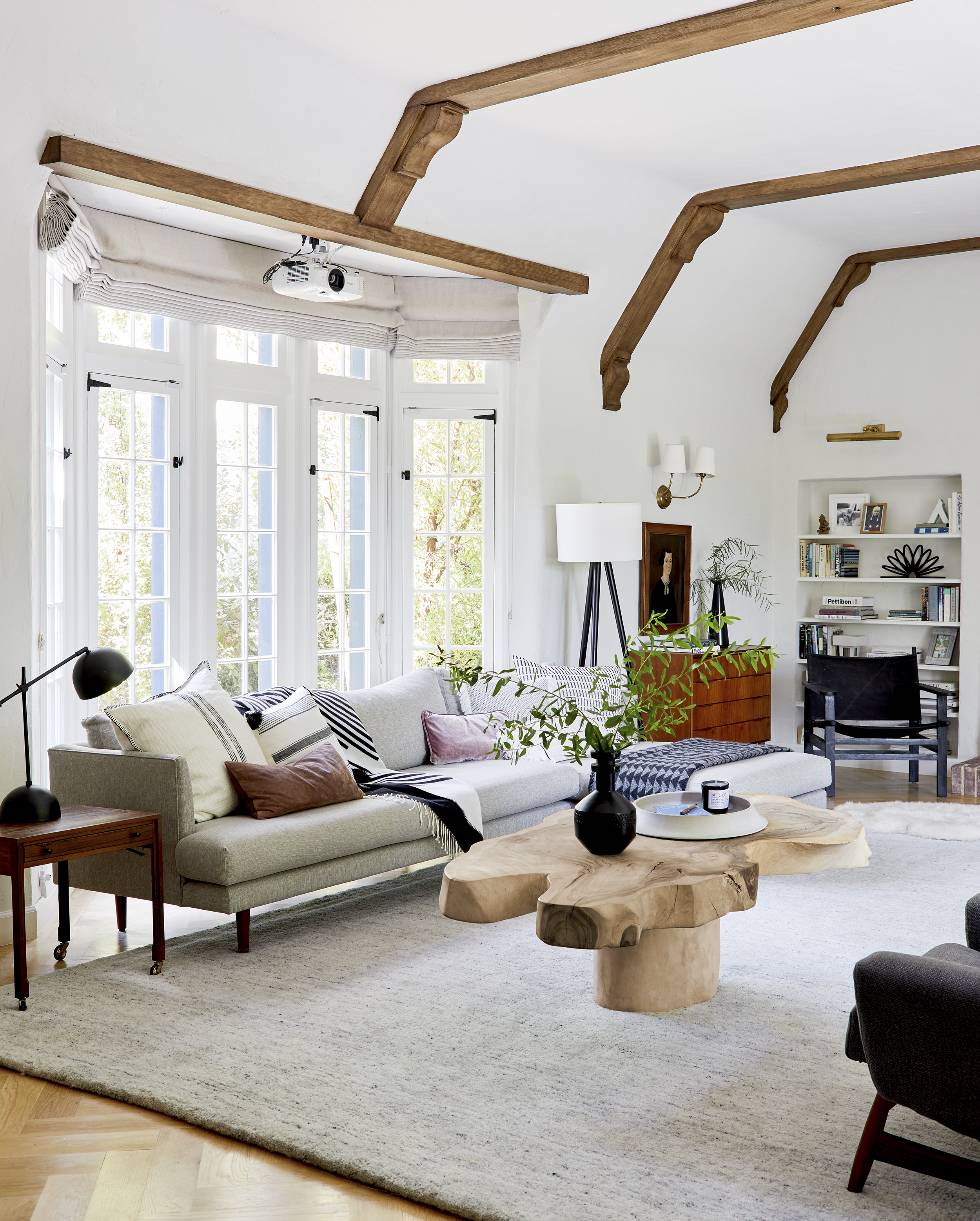 A modern living room with wooden beams and rustic decor