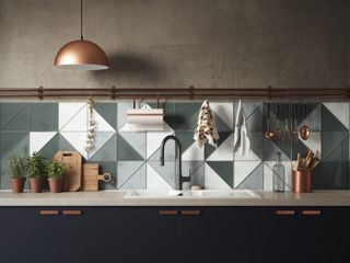 A large blue and white triangle tiled splashback in a brown and grey kitchen with coper lighting