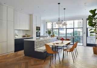 a kitchen island with banquette seating