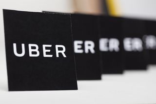 Black cards of Uber logos lined up in a row