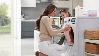 LG Washing machine with woman removing clothes from it