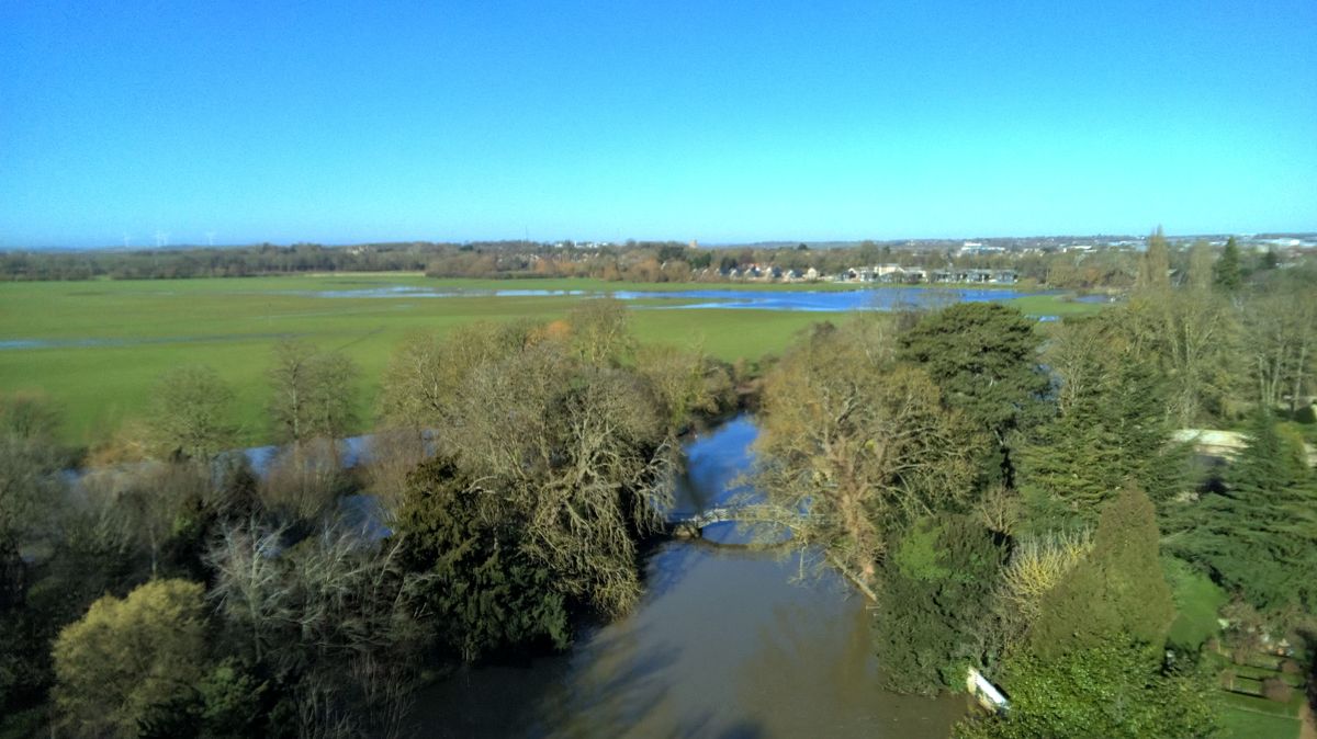 A river lined with trees as seen from the air, taken on a Ruko F11PRO 2 camera drone