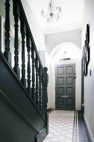 Hallway stairs arched window floor tiling chandelier