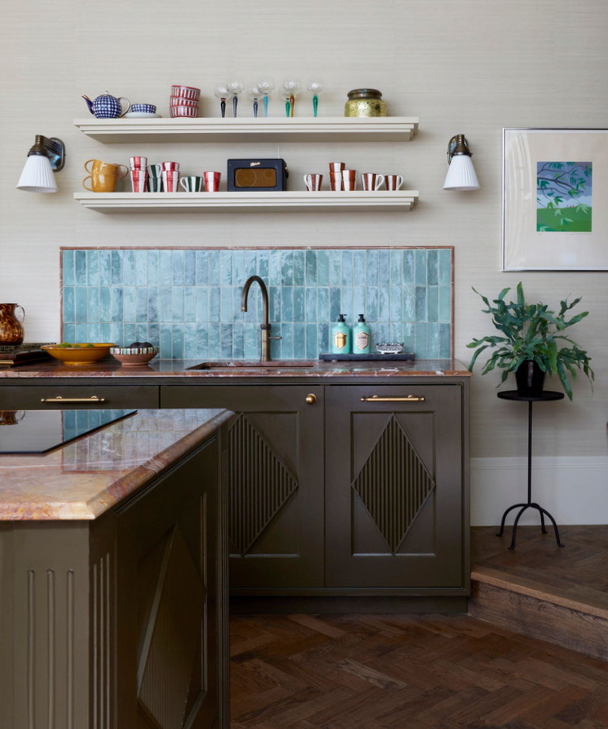 A small kitchen with beige walls, dark green cabinets, and blue backsplash tiles
