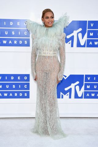 Beyonce attends the 2016 MTV Video Music Awards at Madison Square Garden on August 28, 2016 in a feathered naked dress