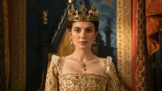 Lady Jane (Emily Bader) wearing the crown and sitting on the throne in Prime Video's "My Lady Jane" 