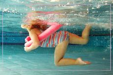 An underwater shot of a young girl swimming in a swimming pool