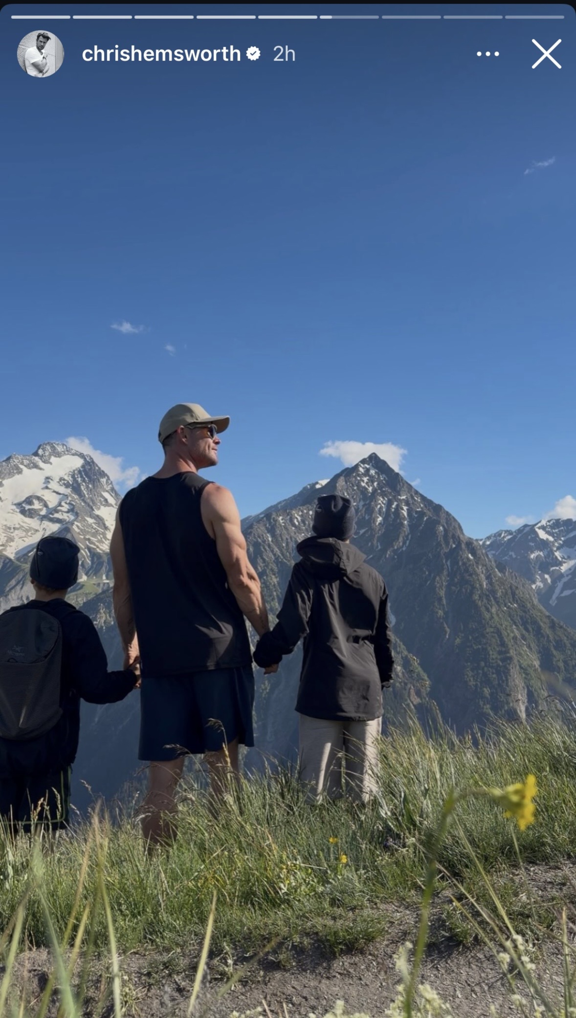 Chris Hemsworth and his two boys looking at the French Alps.
