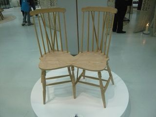 "Lover chair" made from two oak chairs that share part of the seat and one of the legs