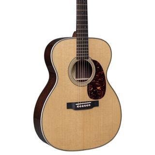 An angled shot of the body of a Martin 000-28 Modern Deluxe acoustic guitar on a white background