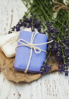 White And Purple Soap Next To Lavender Plants