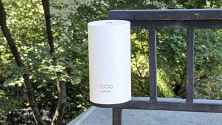 TP-Link Deco BE65-Outdoor mounted on a railing