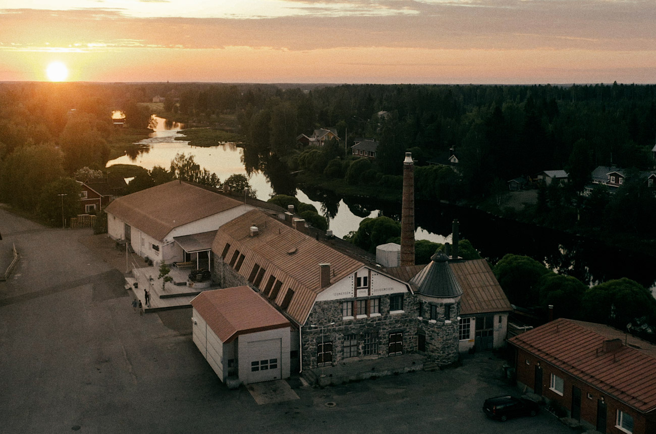 A distillery next to a river at sunset