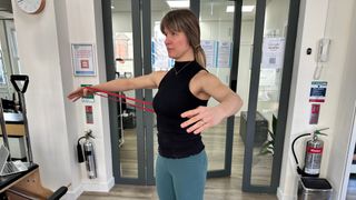 Woman performing a resistance band chest fly